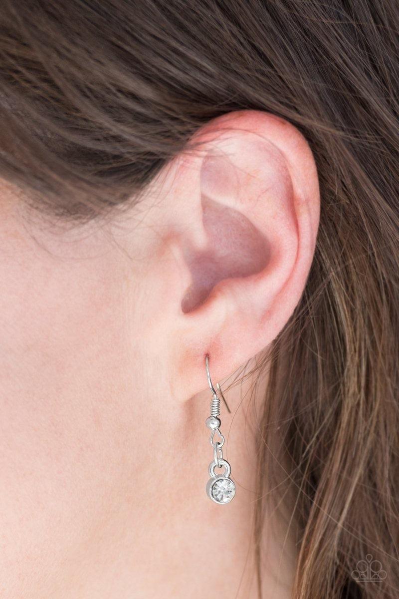 Paparazzi Accessories Million Dollar Drop - White A white teardrop gem is pressed into a sleek silver frame, creating a bold 3-dimensional pendant below the collar. Features an adjustable clasp closure. Sold as one individual necklace. Includes one pair o