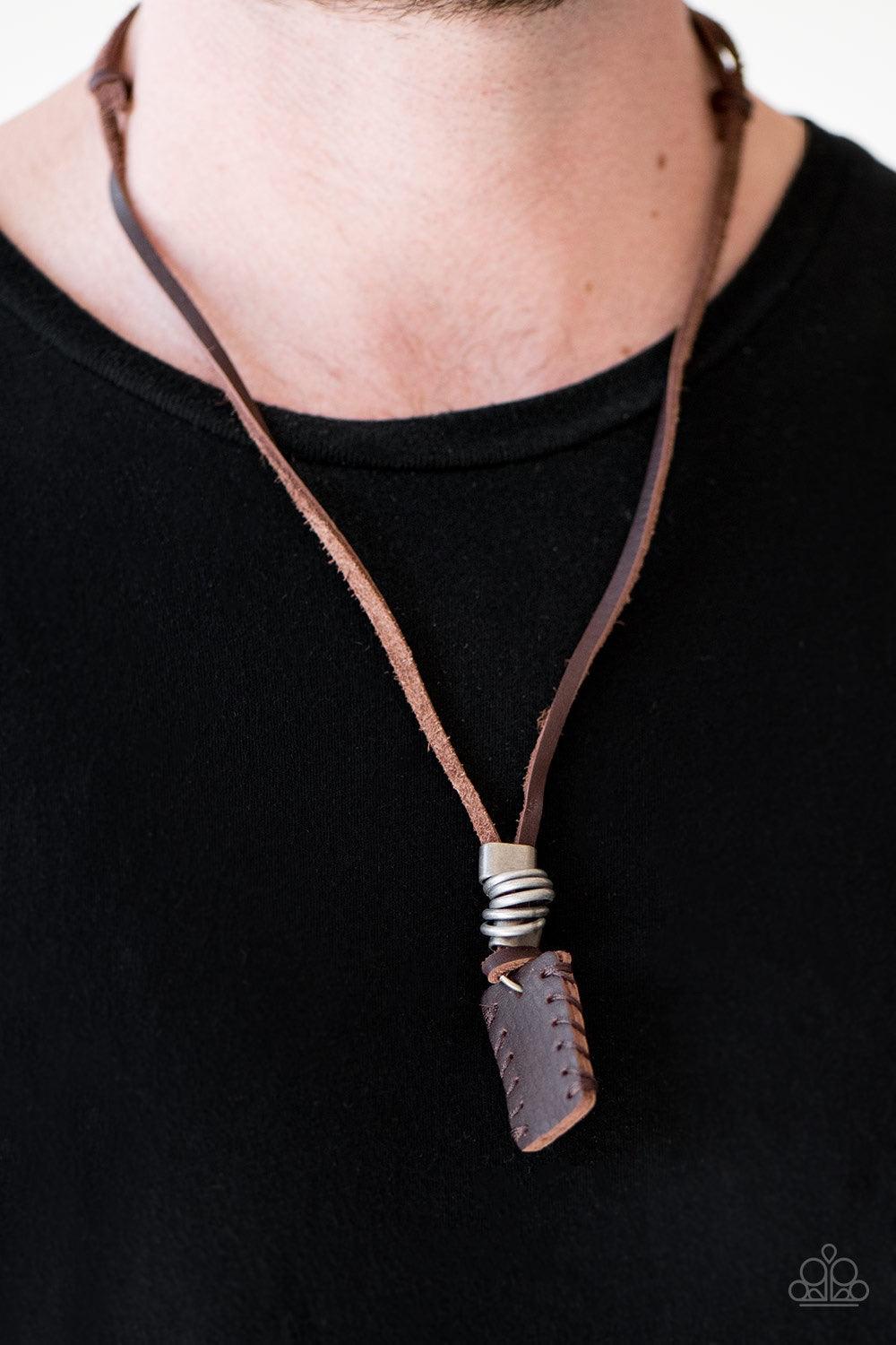 Paparazzi Accessories Alpine Alps - Brown Brushed in an antiqued finish, silver rings and metallic accents slide along knotted leather strands, giving way to a leather pendant for a rustic finish. Features an adjustable sliding knot closure. Jewelry
