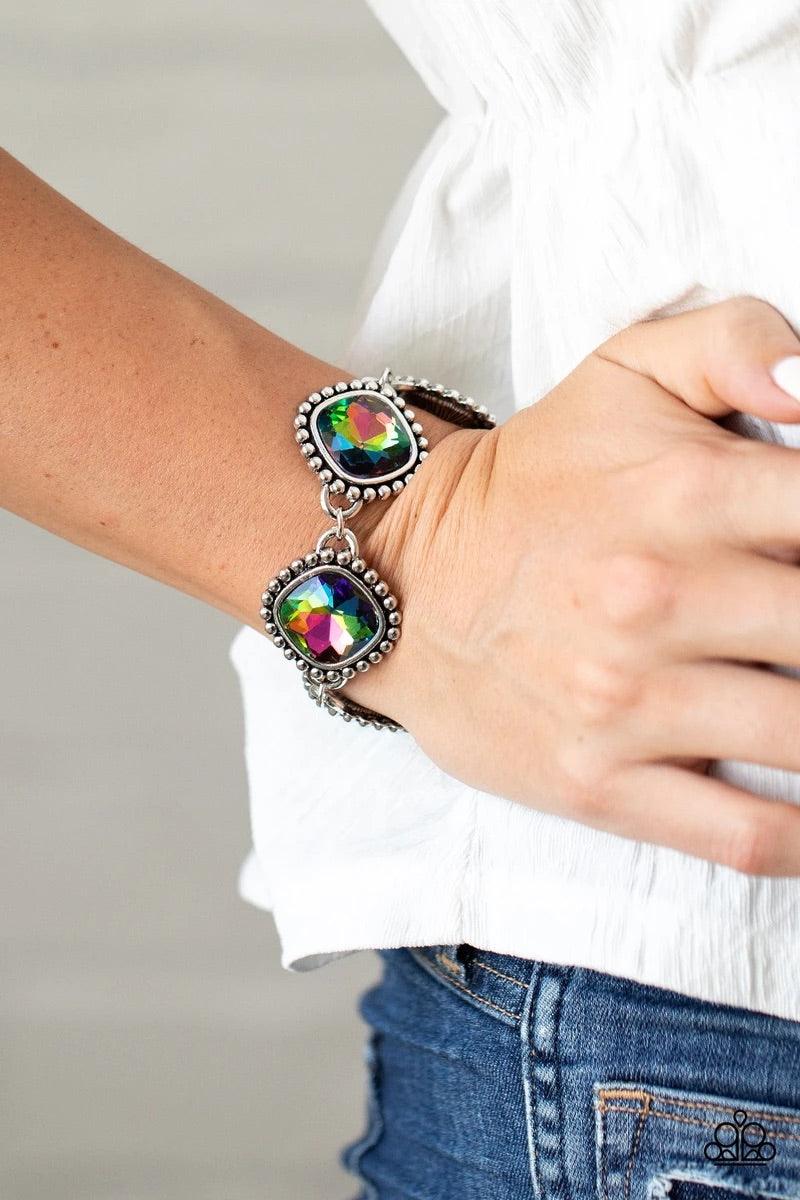 Paparazzi Accessories Megawatt - Multi Featuring dramatically studded silver frames, an exaggerated display of oversized oil spill rhinestone encrusted frames delicately link around the wrist for a blinding look. Features an adjustable clasp closure. Sold