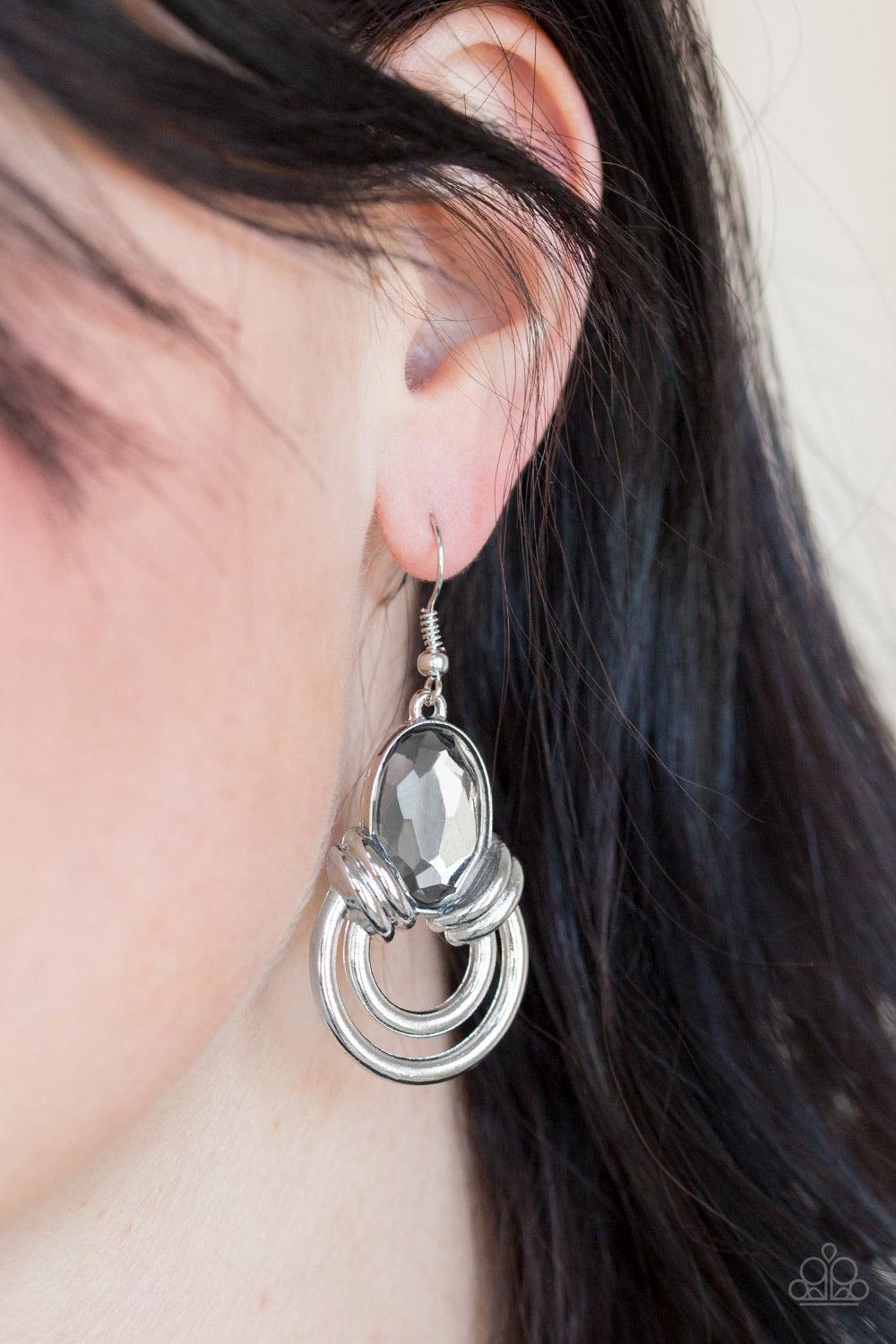 Paparazzi Accessories Real Queen - Silver Shimmery silver hoops radiate from the bottom of a dramatic gem fitting, coalescing into a regal frame. Earring attaches to a standard fishhook fitting. Jewelry