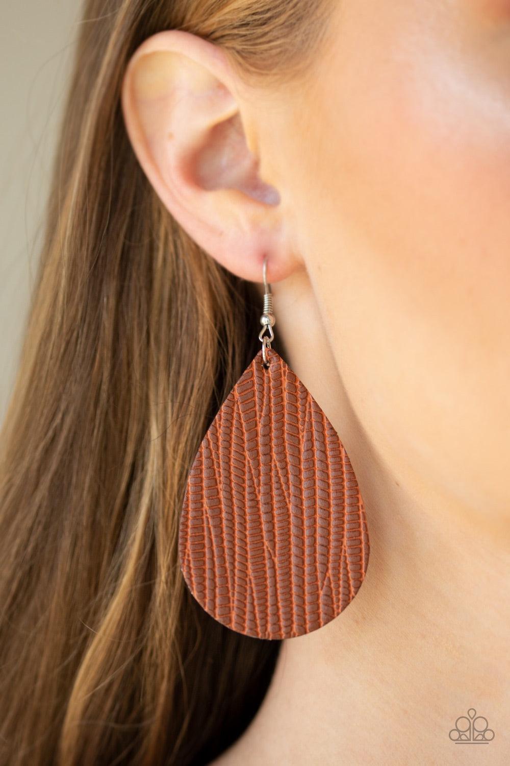 Paparazzi Accessories Natural Resource - Brown Stamped in an animal print inspired pattern, an earthy brown leather teardrop swings from the ear for a trendy vibe. Earring attaches to a standard fishhook fitting. Jewelry