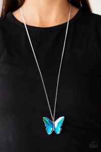 Paparazzi Accessories The Social Butterfly Effect - Blue Featuring a UV effect, dramatically faceted blue and green gems adorn the wings of a silver butterfly, creating an ethereal pendant at the bottom of a lengthened silver chain. Features an adjustable