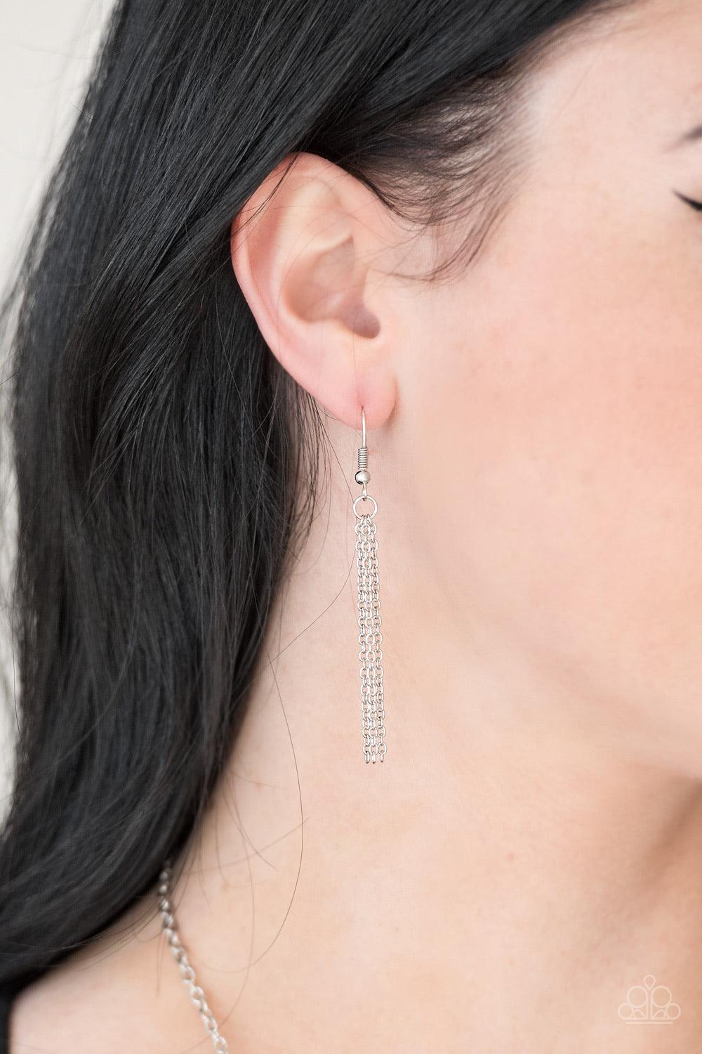 Paparazzi Accessories Paradise Prowess - Silver Radiating in linear textures, antiqued silver plates connect down the chest, creating a tribal inspired pendant. Glistening silver chains swing from the bottom of the stacked pendant, adding a whimsical tass