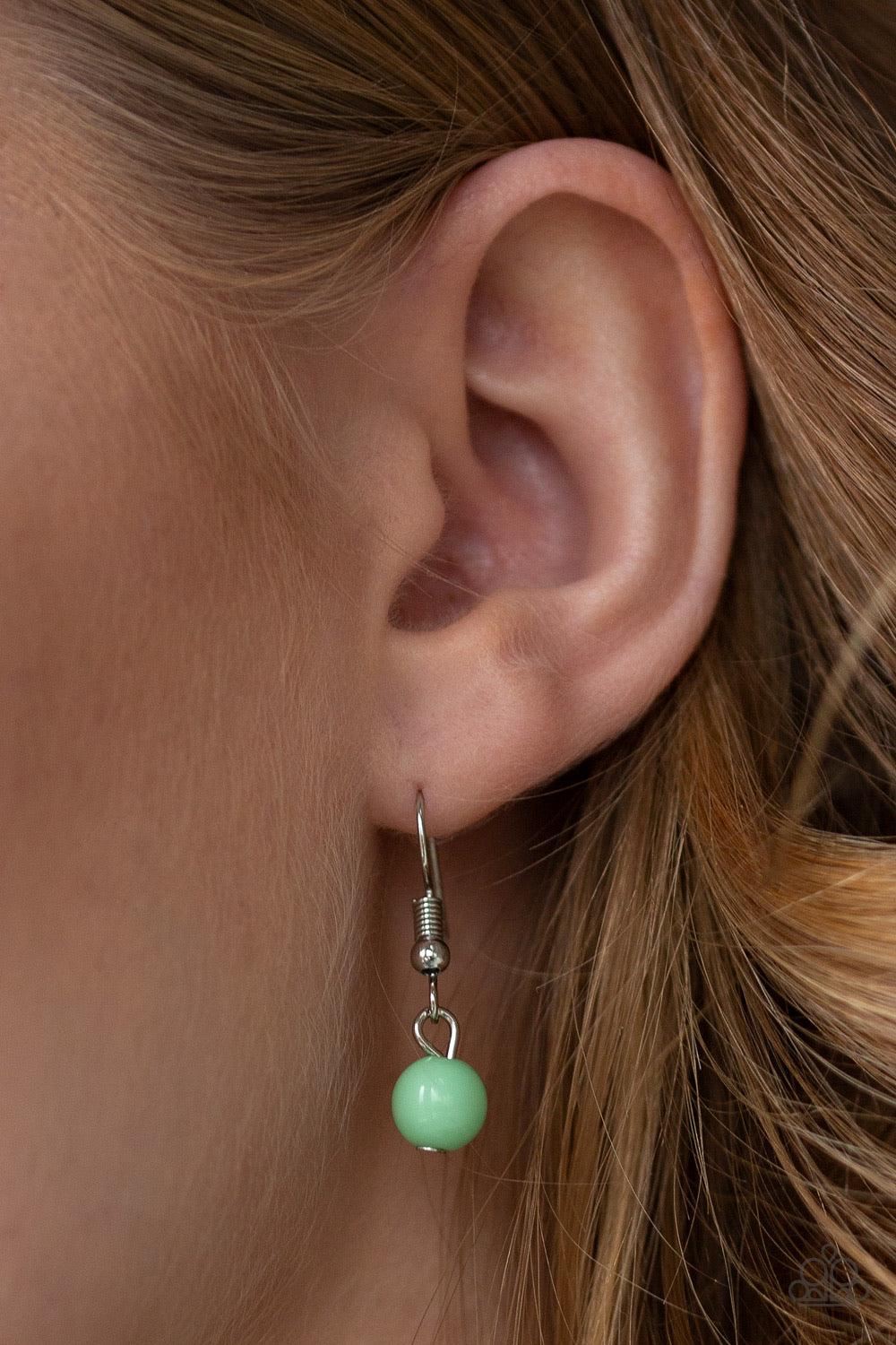 Paparazzi Accessories Wait And Sea - Green Infused with layers of mismatched silver chains, glassy, polished green, and glittery white rhinestones swing from the bottom of a bold silver chain, creating a bubbly fringe below the collar. Features an adjusta