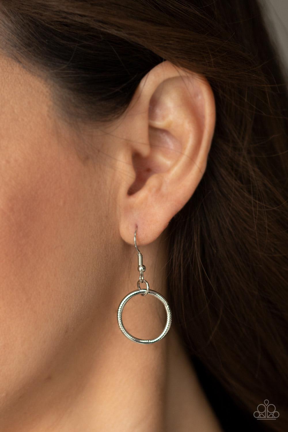 Paparazzi Accessories Salvage Yard - Silver Hammered in shimmery detail, oversized asymmetrical silver rings and gritty silver links boldly link below the collar in two dramatic rows for a sassy industrial look. Features an adjustable clasp closure. Sold