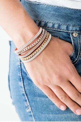 Paparazzi Accessories Fashion Fiend - Orange Glassy white and smoky rhinestones are encrusted along strands of orange suede. Glistening silver and gold chains are added to the bands, adding edgy industrial shimmer to the sassy palette. Features an adjusta