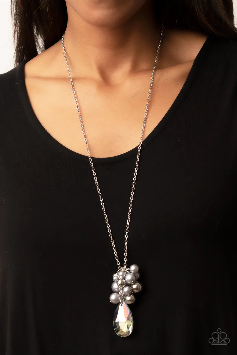 Paparazzi Accessories Drip Drop Dazzle - Silver Featuring an iridescent shimmer, a dramatically oversized crystal-like teardrop swings from the bottom of a cluster of shiny silver, pearly silver, and crystal-like beads, creating a dazzling pendant at the