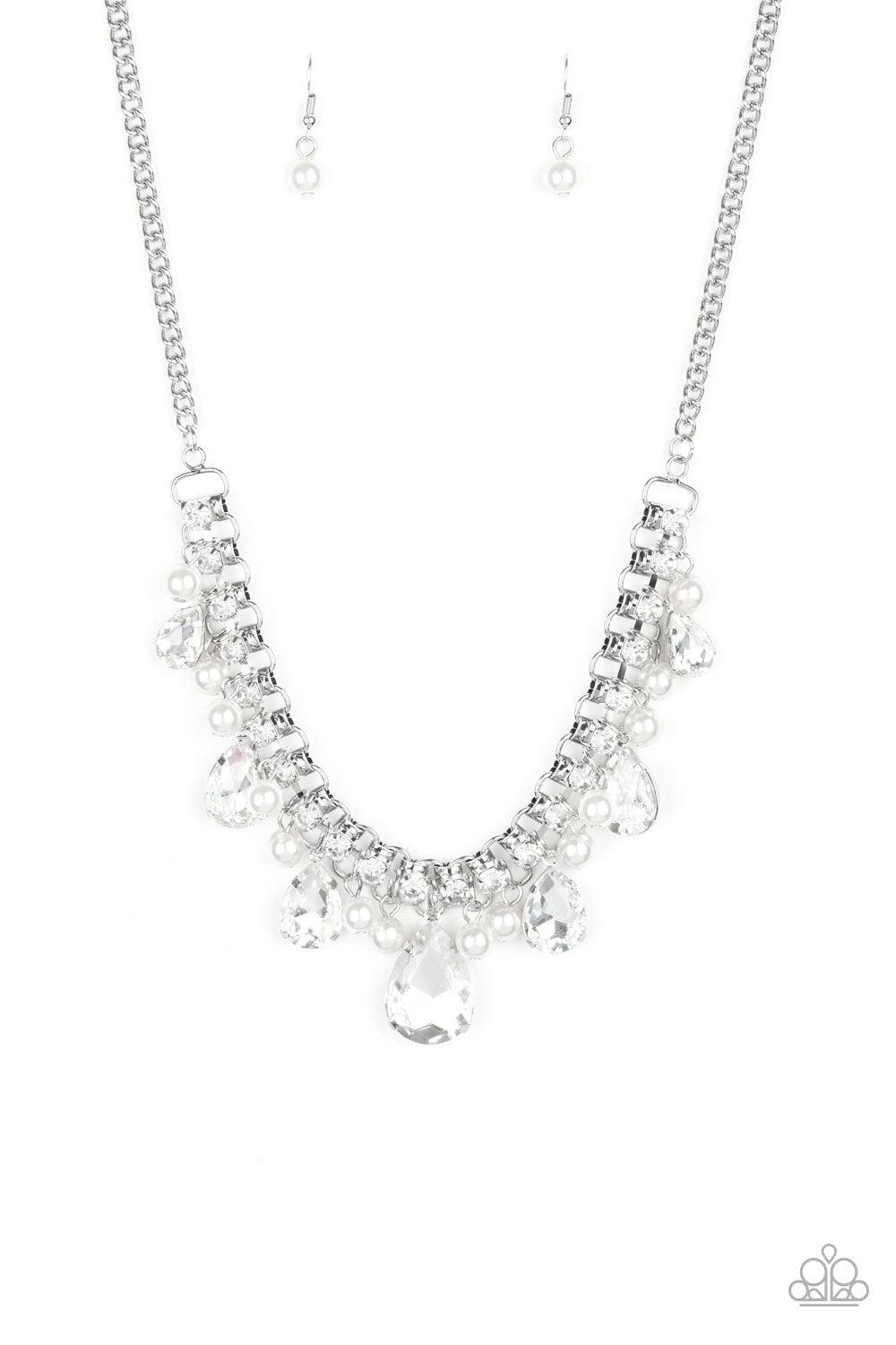 Paparazzi Accessories Knockout Queen - White A glamorous collection of bubbly white pearls and exaggerated white teardrop gems dangle from a bold strand of white rhinestones, creating a knockout fringe below the collar. Features an adjustable clasp closur