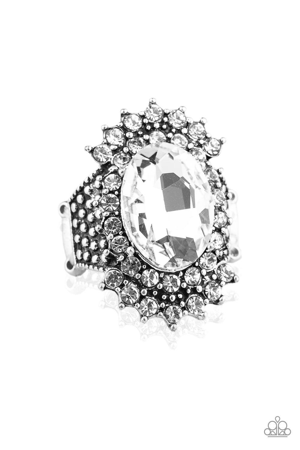 Paparazzi Accessories Him And HEIR - White Glittery white rhinestones flare out from a dramatically oversized white rhinestone center. The regal frame sits atop a silver studded band for a statement-making finish. Features a stretchy band for a flexible f