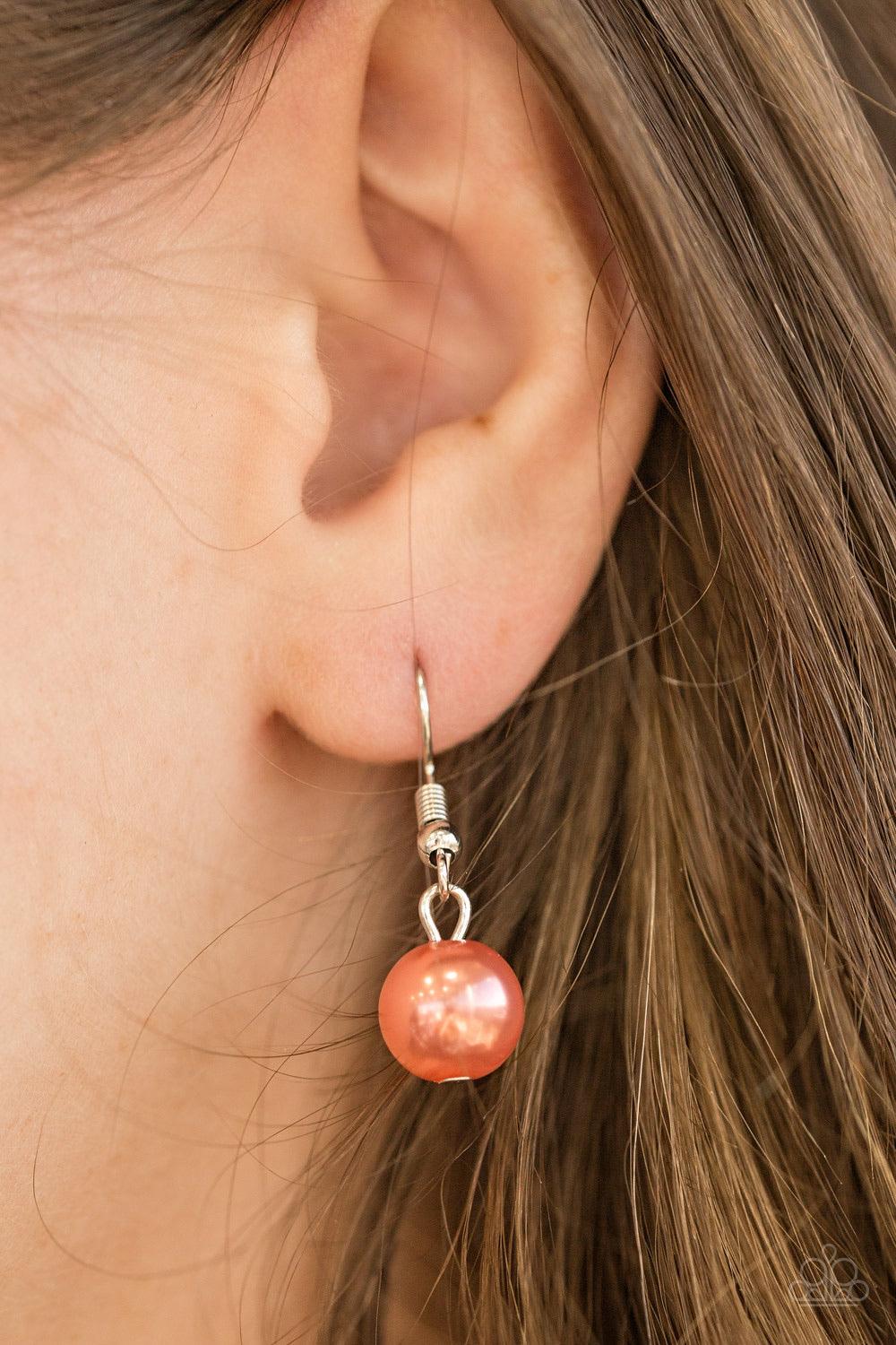 Paparazzi Accessories Run The Show - Orange Classic coral pearls trickle from the bottom of a glistening silver chain. Shimmery silver hoops cascade from the pearls, creating a flirty fringe below the collar. Features an adjustable clasp closure. Sold as