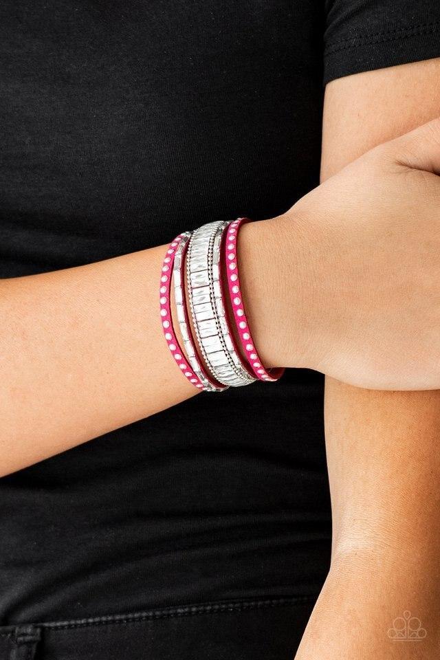 Paparazzi Accessories Rock Star Rocker - Pink Shiny silver studs, dainty silver ball chains, and edgy white emerald-cut rhinestones race along a spliced pink suede band for a rock star look. Features an adjustable snap closure.Sold as one individual brace