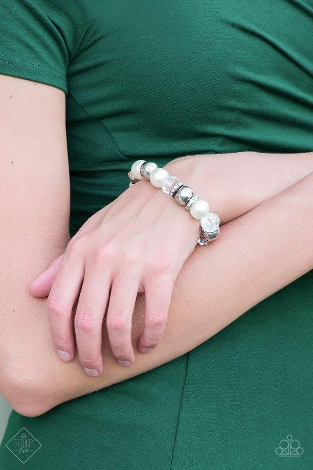 Paparazzi Accessories Camera Chic ~White Oversized silver, crystal-like, and pearly white beads are threaded along a stretchy elastic band and wrapped around the wrist for a glamorous look. White rhinestone encrusted rings are sprinkled between the dramat