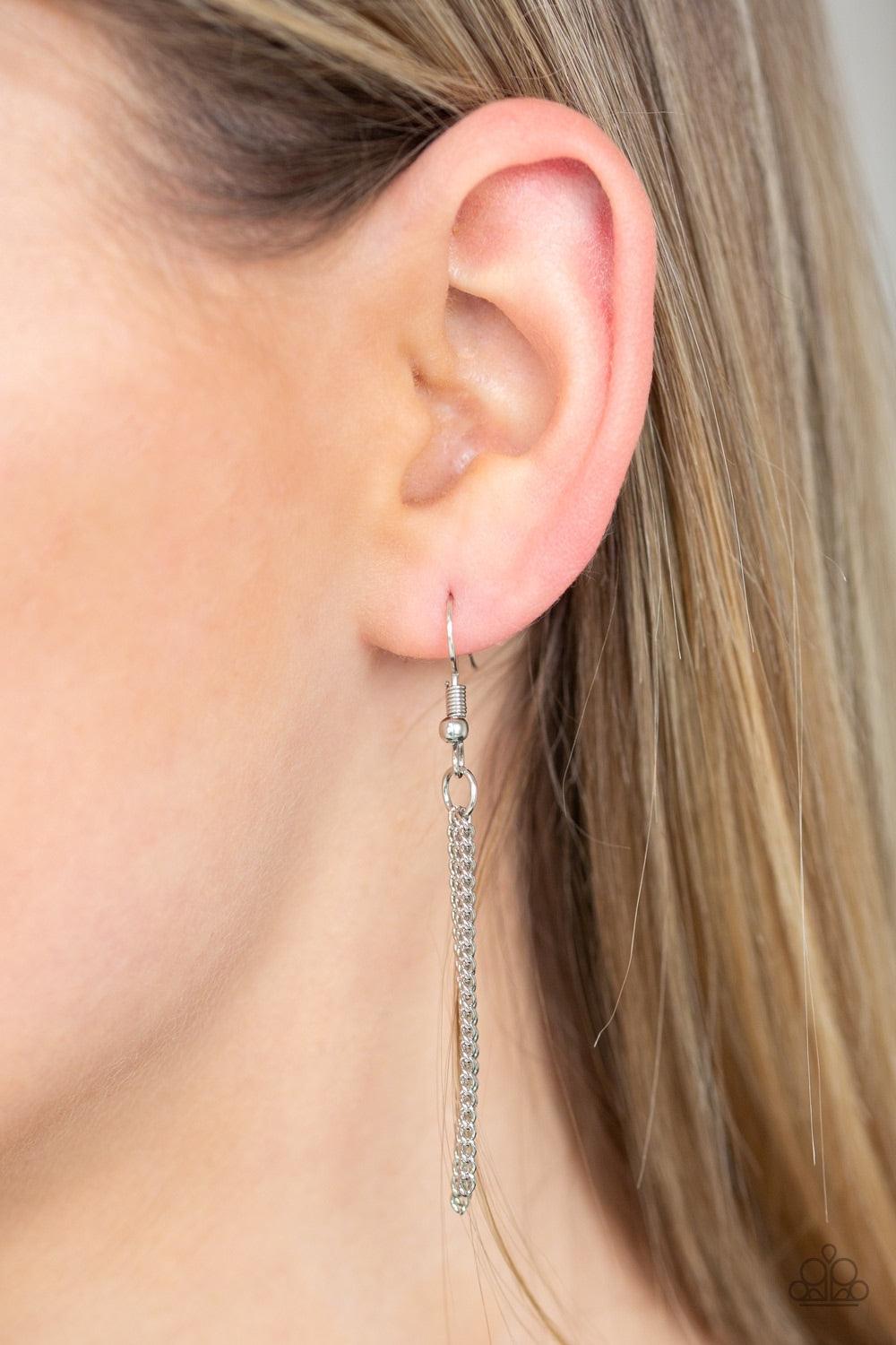 Paparazzi Accessories Metro Must Have - Red An oversized red gem swings from the top of an airy silver frame, creating a refined double pendant at the bottom of a lengthened silver chain. As if dipped in glitter, the bottom of the silver frame is encruste