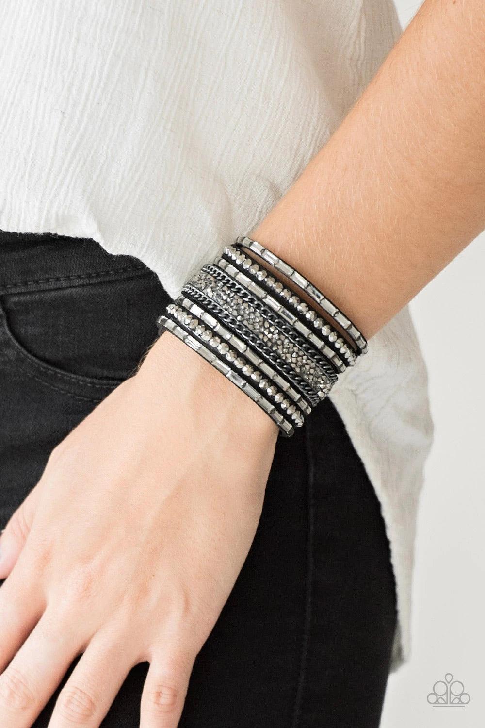 Paparazzi Accessories Rhinestone Rumble ~Black Smoky emerald-cut rhinestones, hematite rhinestones, and metallic prism-shaped rhinestones are sprinkled along strands of black suede. Shimmery gunmetal chain is added to the mix for a sassy industrial finish