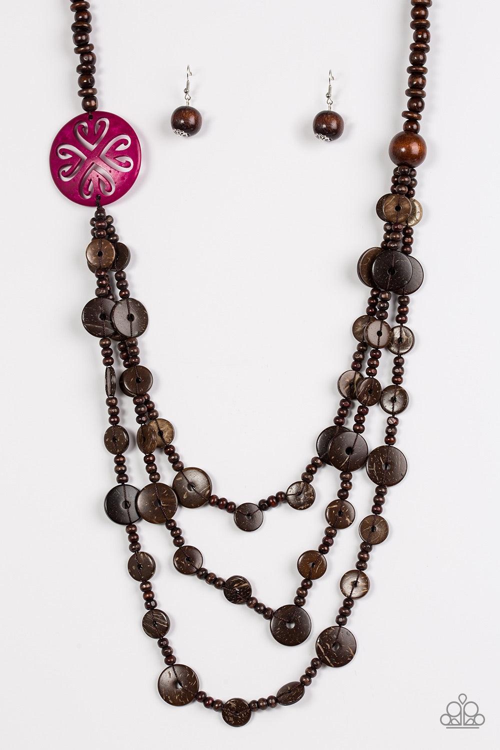 Paparazzi Accessories Jungle Jive - Pink Mismatched brown wooden beads are threaded along a shiny brown string, creating summery layers across the chest. Featuring a whimsical floral pattern, a dramatic pink wooden bead adorns one side for a seasonal fini