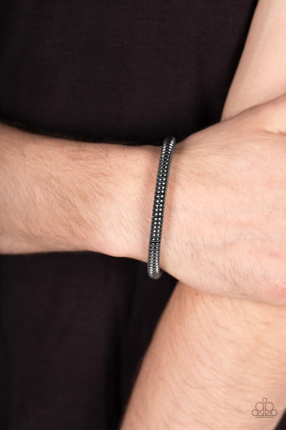 Paparazzi Accessories Turbocharged - Black A glistening gunmetal cable has been wrapped tightly around a gunmetal cuff, creating edgy shimmer around the wrist. Sold as one individual bracelet. Jewelry