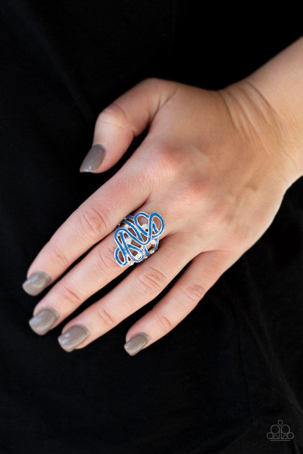 Paparazzi Accessories The Run Around - Blue Painted in a shiny blue finish, glistening silver ribbons whirl around dainty white rhinestones, coalescing into a whimsical frame atop the finger. Features a stretchy band for a flexible fit. Sold as one indivi