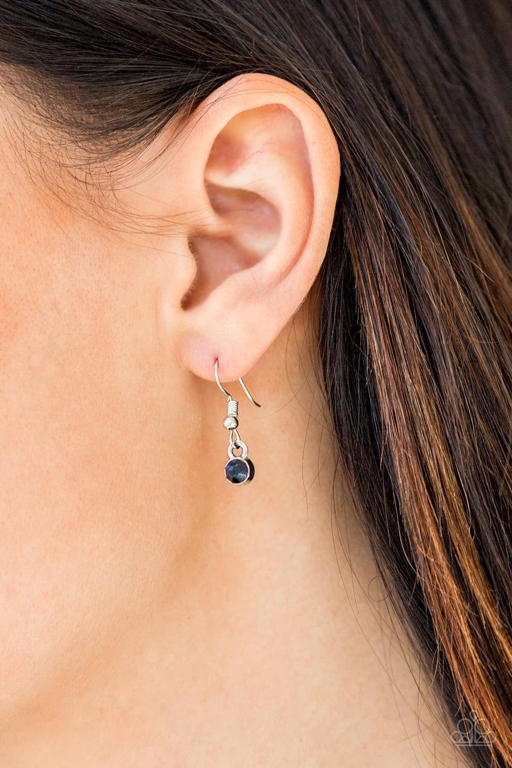 Paparazzi Accessories Money Mood - Blue Ringed in a studded silver frame, glittery blue and white rhinestones collect into a glamorous pendant at the bottom of a lengthened silver chain for a refined flair. Features an adjustable clasp closure. Sold as on