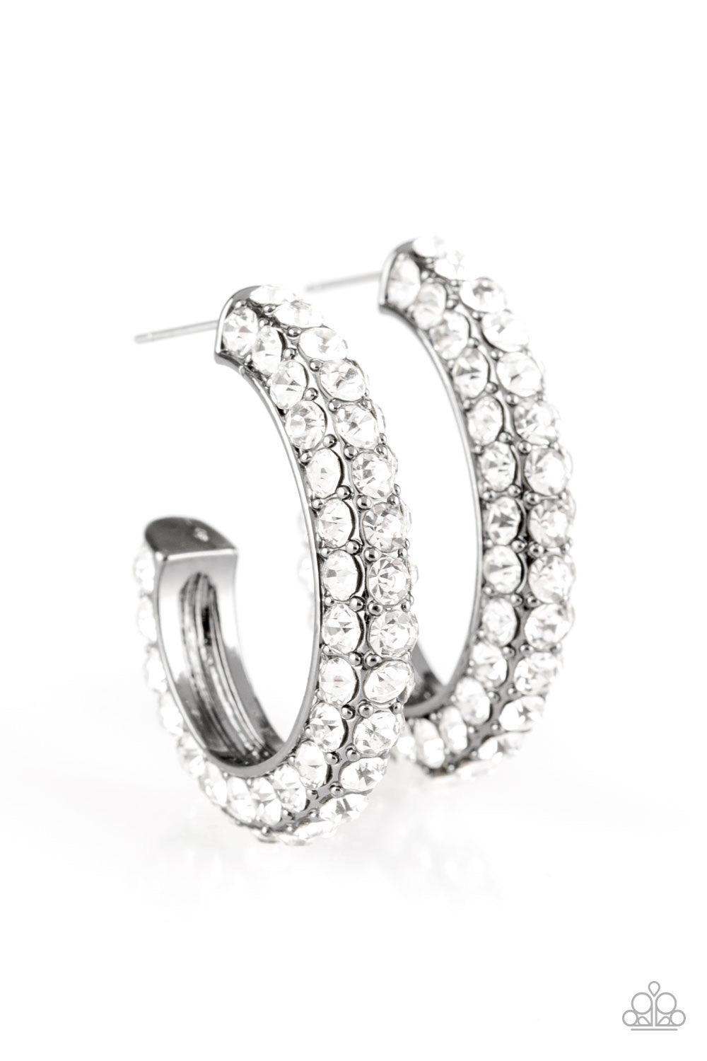 Paparazzi Accessories Don’t Mind The Stardust - Black As if rolled in glitter, a shimmery gunmetal hoop is encrusted in row after row of sparkling white rhinestones for a show-stopping look. Earring attaches to a standard post fitting. Hoop measures 1" in