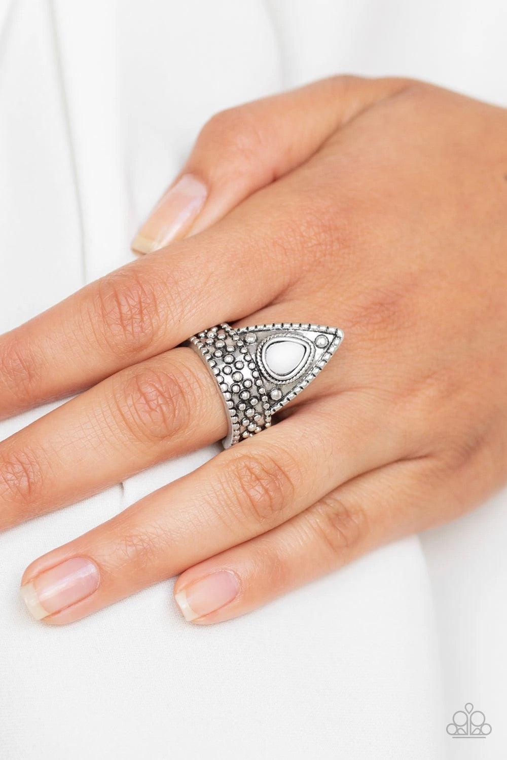 Paparazzi Accessories Tropical Escapade - White A shiny white bead is pressed into the center of a triangular frame atop a studded silver band for a seasonal flair. Features a dainty stretchy band for a flexible fit.Sold as one individual ring. Jewelry