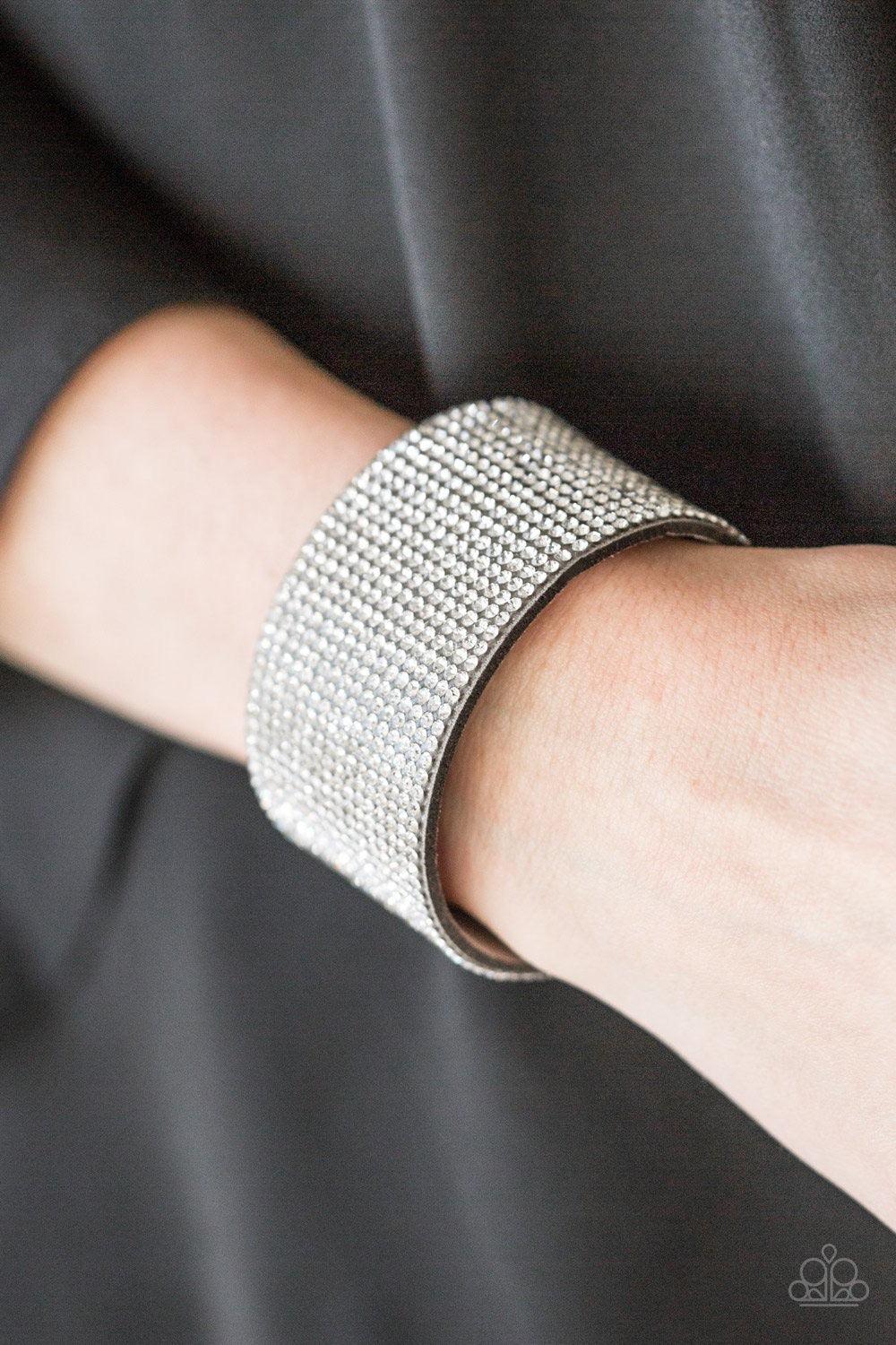 Paparazzi Accessories Roll With The Punches - Silver Row after row of glassy white rhinestones are encrusted along a thick gray suede band, creating knockout shimmer across the wrist. Features an adjustable snap closure. Sold as one individual bracelet. J