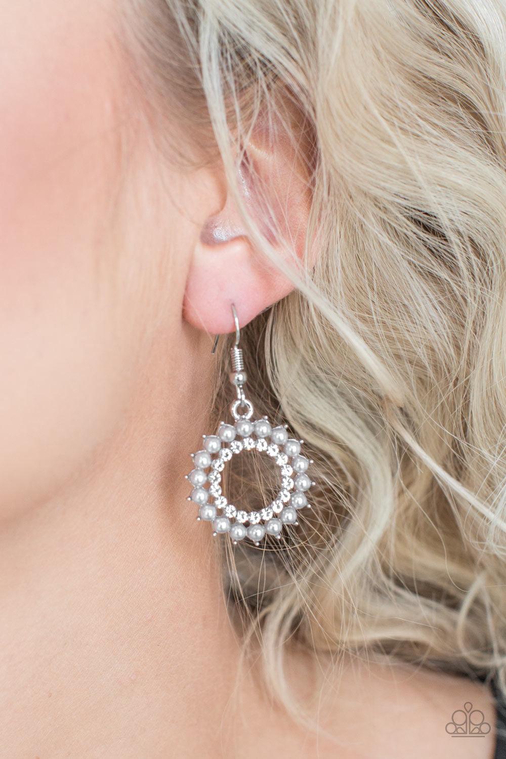 Paparazzi Accessories Wreathed in Radiance - Silver Dainty silver pearls spin around a radiant white rhinestone center, coalescing into a refined hoop. Earring attaches to a standard fishhook fitting. Earrings
