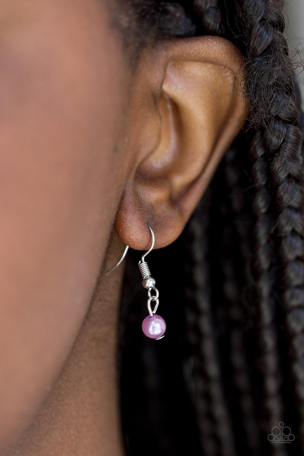 Paparazzi Accessories Speaking of Timeless - Purple Alternating in silver studs and glassy white rhinestones, dainty silver bars fold around a sparkling mishmash of glassy white rhinestones and dainty purple pearls. The sparkling pendant swings below the