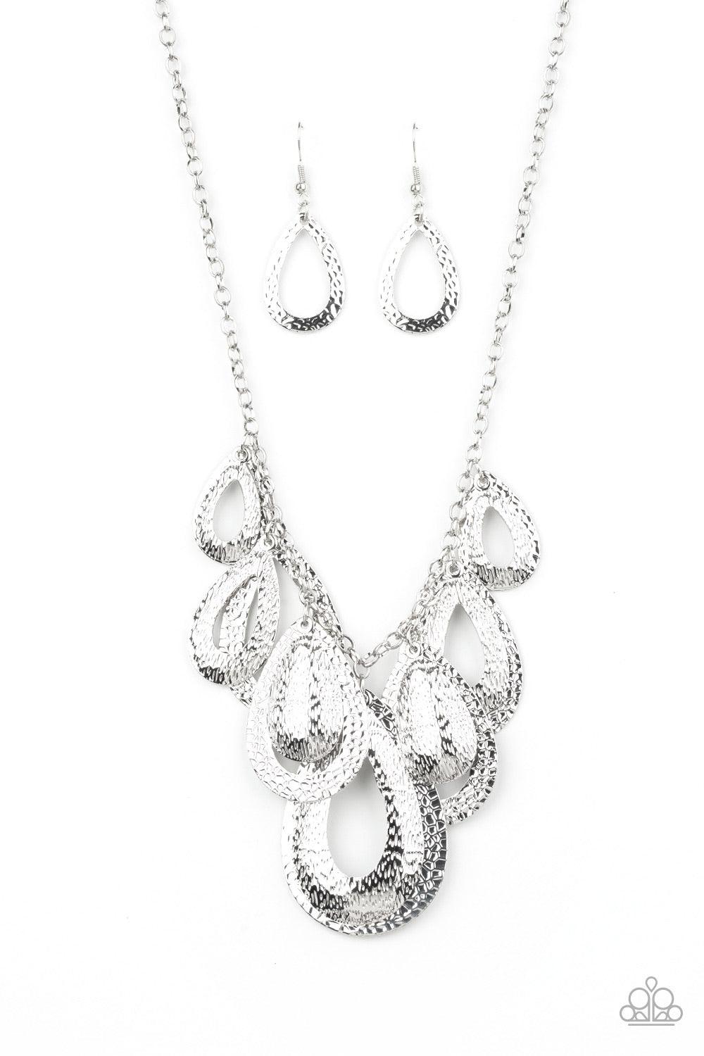 Paparazzi Accessories Teardrop Tempest - Silver Hammered in a blinding textured finish, pairs of mismatched silver teardrops gradually increase in size as they drip below the collar, creating a statement-making fringe. Features an adjustable clasp closure