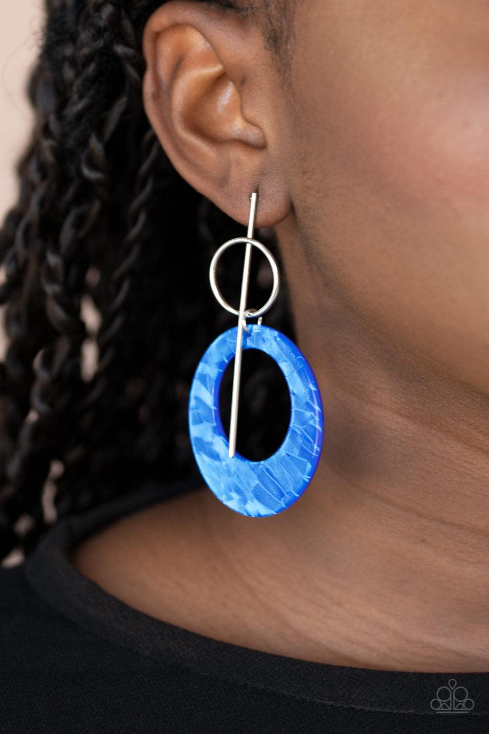 Paparazzi Accessories Stellar Stylist - Blue An iridescent blue acrylic hoop swings from the bottom of a silver ring that is threaded along a dainty silver bar for a retro look. Earring attaches to a standard post fitting. Sold as one pair of post earring