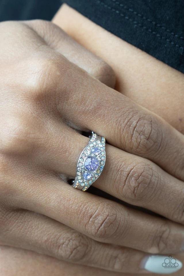 Paparazzi Accessories Celestial Crowns - Purple A trio of brilliant Amethyst Orchid rhinestones are set inside a glittering rhinestone encrusted frame creating a divinely heavenly essence atop the finger. Features a dainty stretchy band for a flexible fit