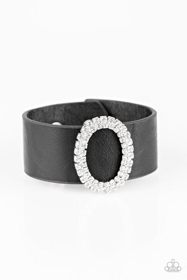 Paparazzi Accessories Center Stage Starlet - Black Encrusted in glassy white rhinestones, a round silver frame slides along a thick black leather band for a glamorous look. Features an adjustable snap closure. Jewelry