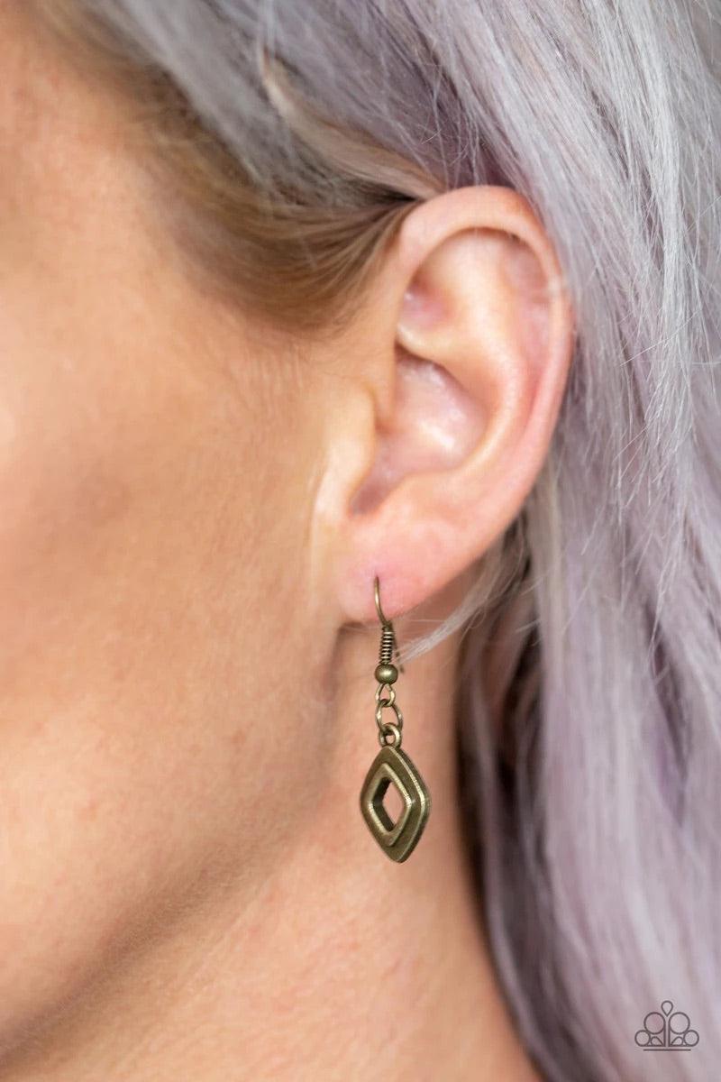 Paparazzi Accessories Geocentric - Brass Brushed in an antiqued shimmer, glistening diamond-shaped brass frames link below the collar, coalescing into an edgy geometric fringe. Features an adjustable clasp closure. Sold as one individual necklace. Include
