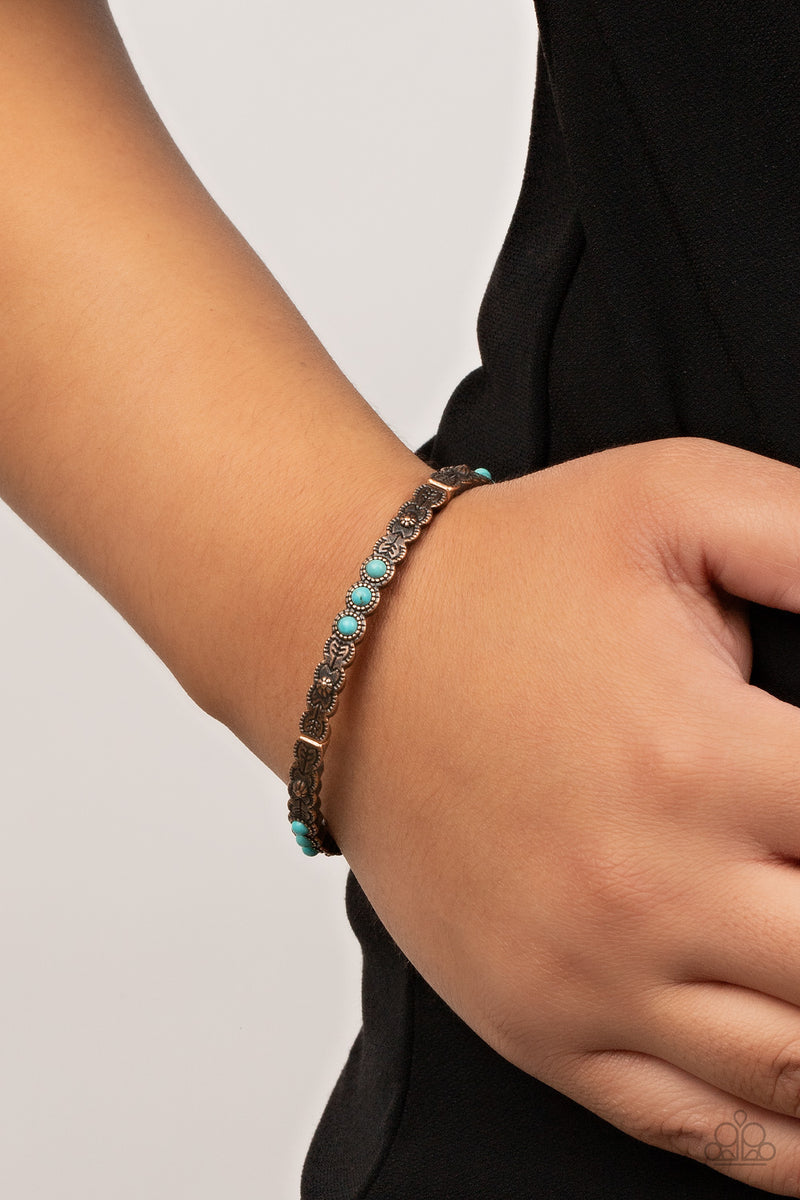 Paparazzi Accessories Living In The Pasture - Copper Stamped and studded in floral and arrow patterns, dainty copper frames adorned in trios of smooth turquoise stones are threaded along stretchy bands around the wrist for a colorfully seasonal look. Sold
