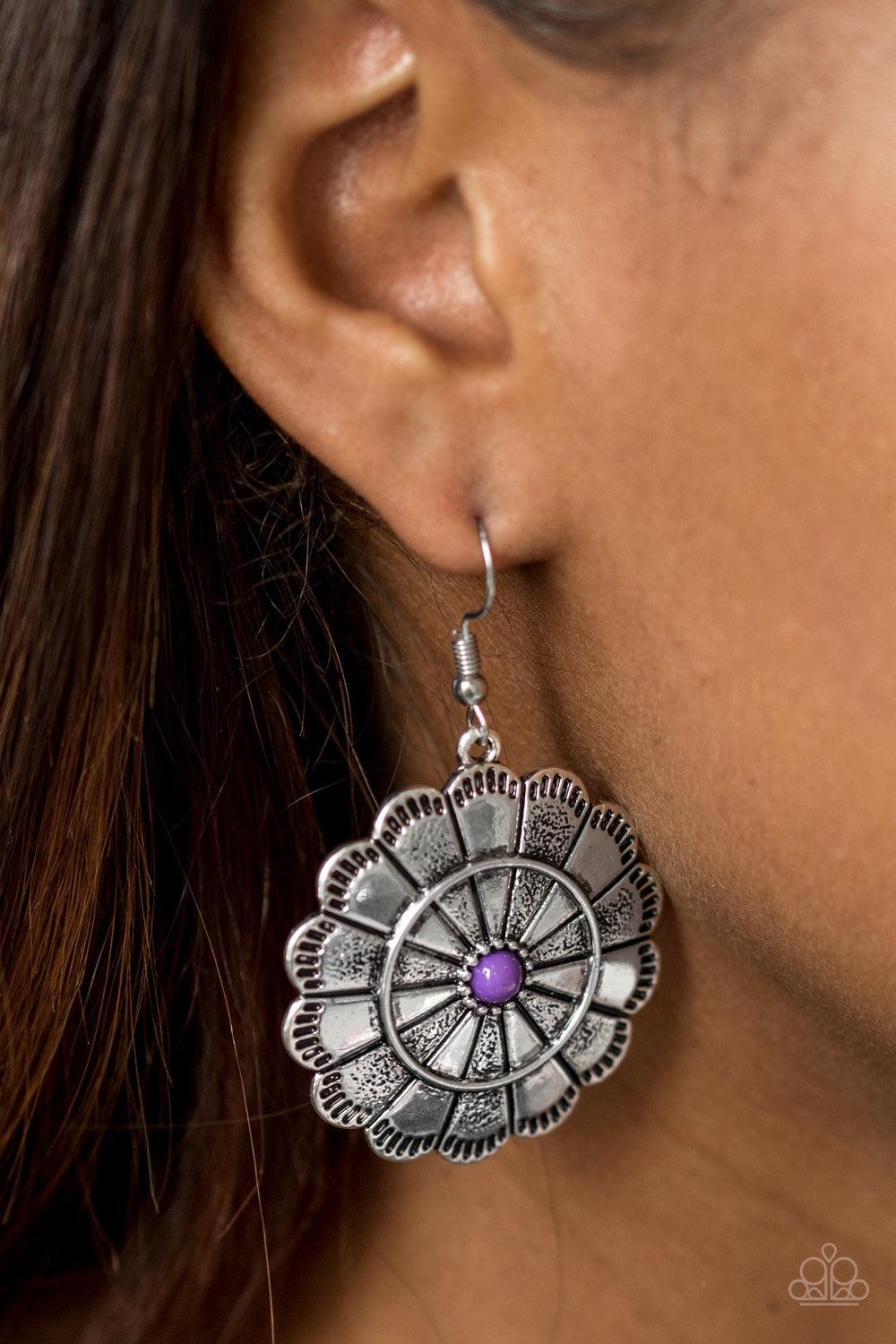 Paparazzi Accessories I’m No Wallflower - Purple Shimmery silver petals bloom from a vivacious purple center for a seasonal look. Etched in serrated edges, alternating petals have been delicately hammered in texture, adding depth and shimmer to the whimsi