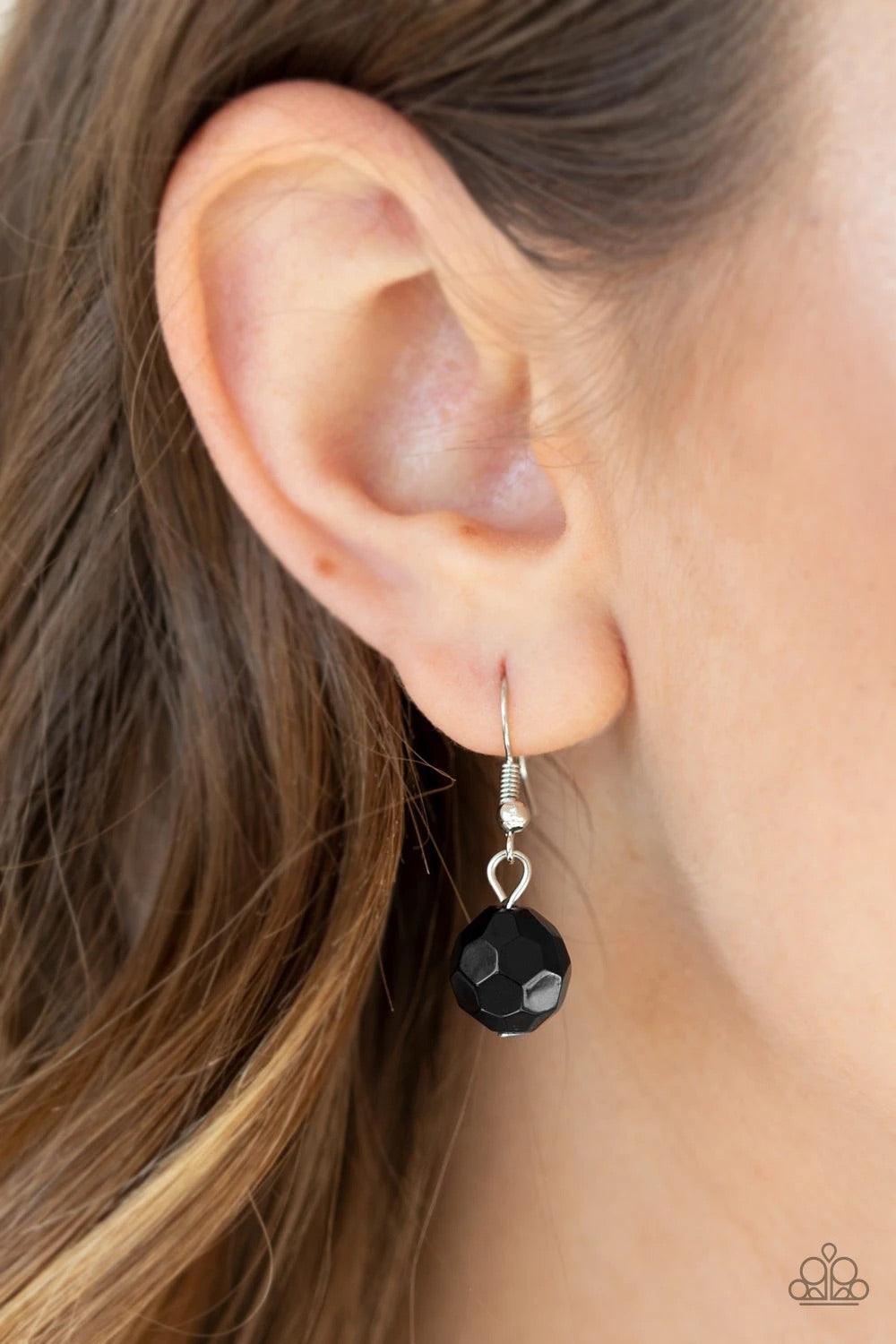 Paparazzi Accessories Treasure Shore - Black A collection of glassy black beads swings playfully from the bottom of a dramatic silver chain. Glistening silver discs trickle between the colorful beads, creating a refreshing fringe below the collar with shi