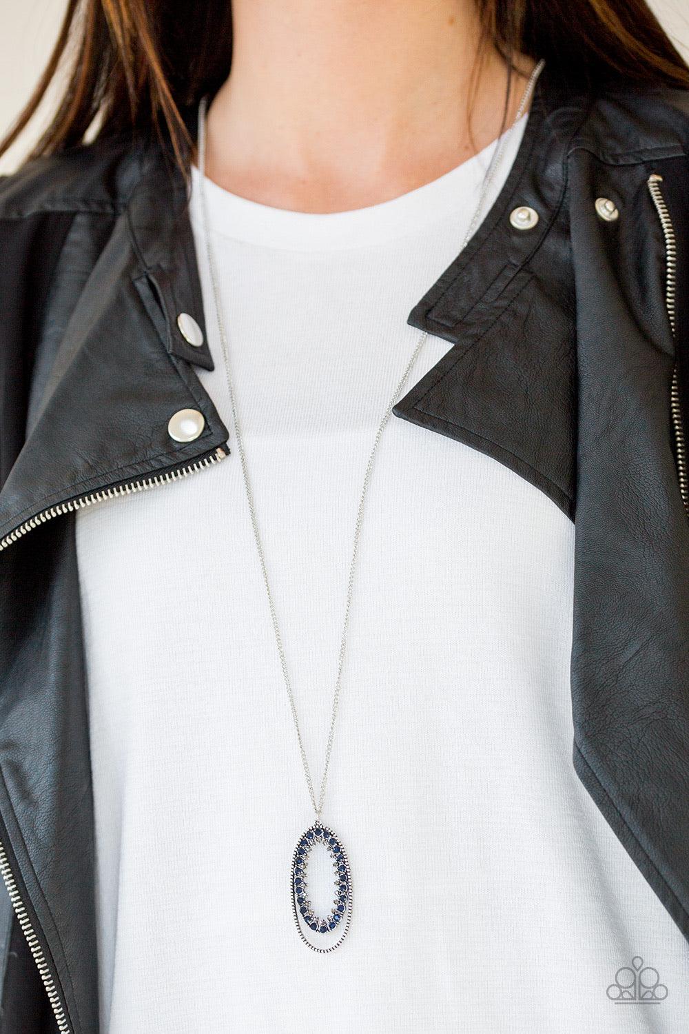 Paparazzi Accessories Money Mood - Blue Ringed in a studded silver frame, glittery blue and white rhinestones collect into a glamorous pendant at the bottom of a lengthened silver chain for a refined flair. Features an adjustable clasp closure. Sold as on