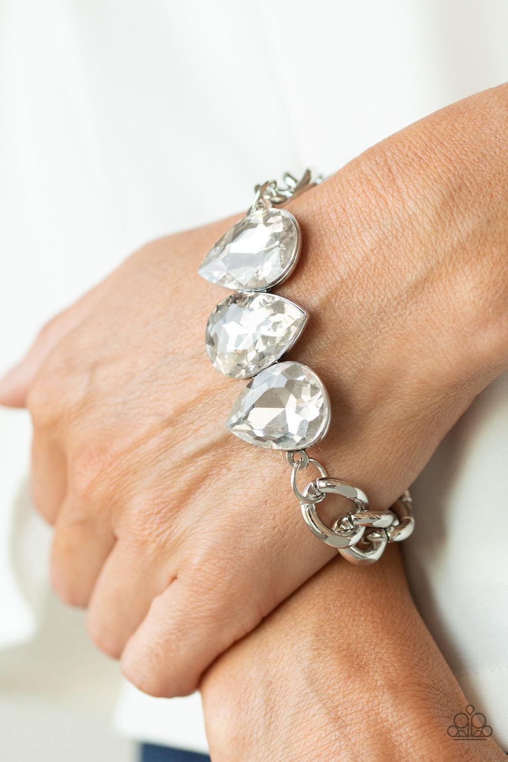 Paparazzi Accessories Bring Your Own Bling - White Three oversized white teardrop gems join at the center of a dramatic silver chain, creating a jaw-dropping display across the wrist. Features an adjustable clasp closure. Jewelry