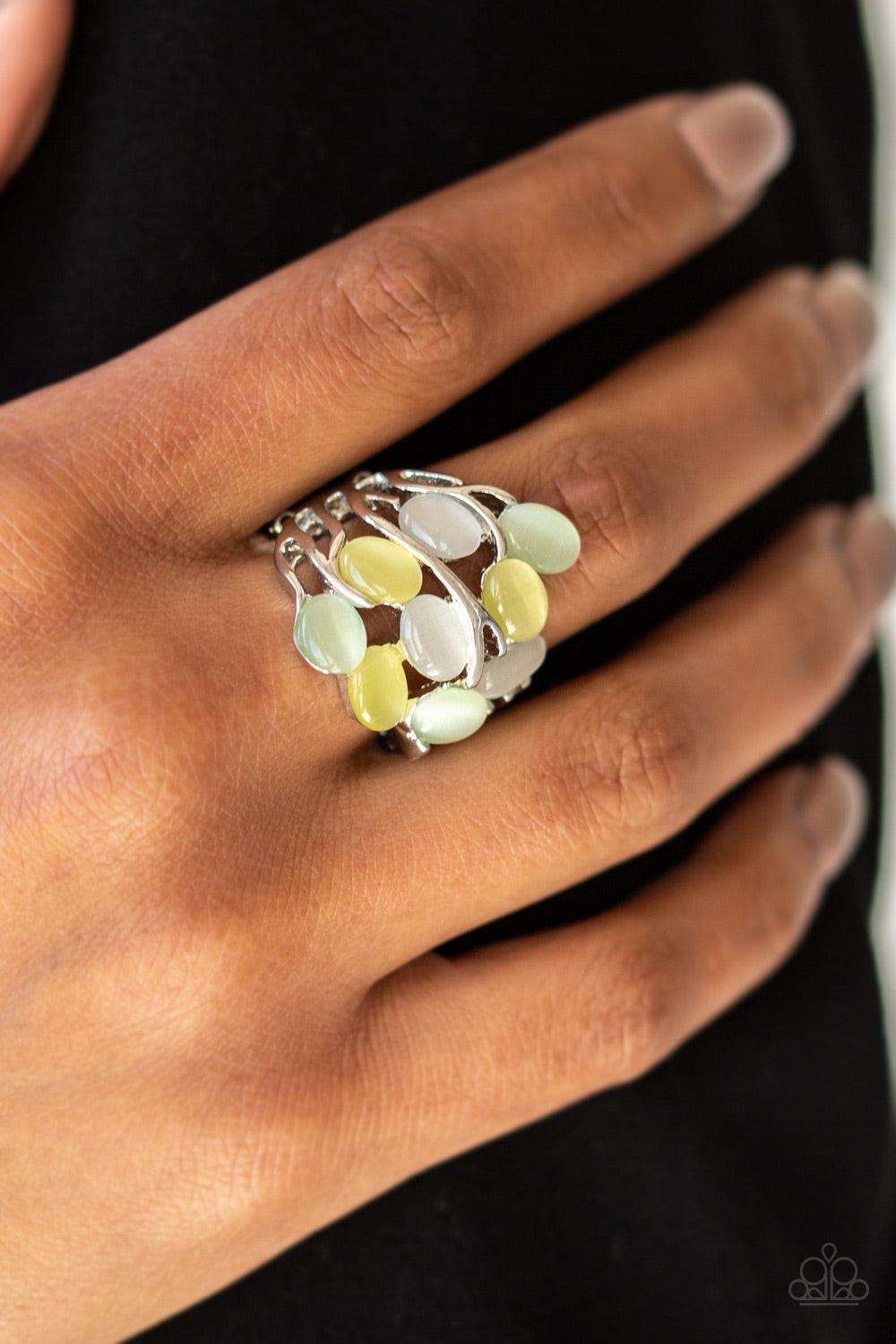 Paparazzi Accessories Really Starting to GLOW on Me ~Green Attached to shimmery silver bands, glowing moonstones are scattered across the finger for a whimsical look. Features a stretchy band for a flexible fit.