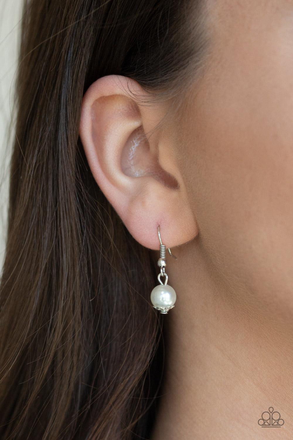 Paparazzi Accessories Tour De Demure - White Infused with two layers of dainty silver chains, pearly white and sparkling crystal-like beads link below the collar for a demure look. Features an adjustable clasp closure. Jewelry