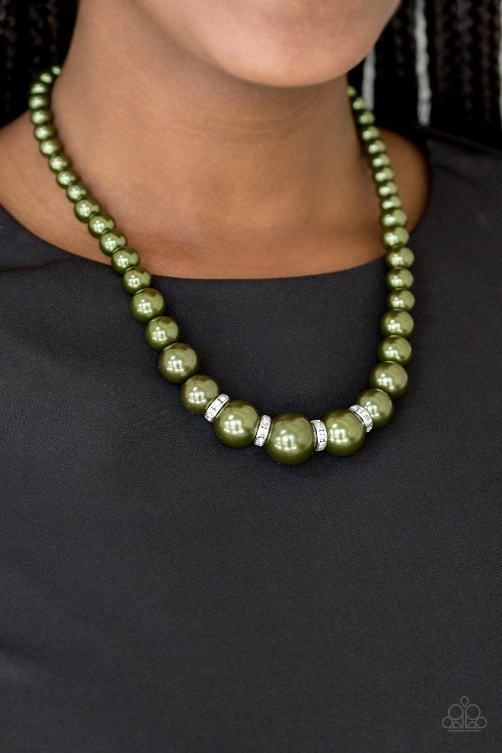 Paparazzi Accessories Party Pearls - Green Gradually increasing in size, luminescent green pearls trickle below the collar for a classic look. Encrusted in dazzling white rhinestones, glittery rings are sprinkled between the pearls for a timeless finish.