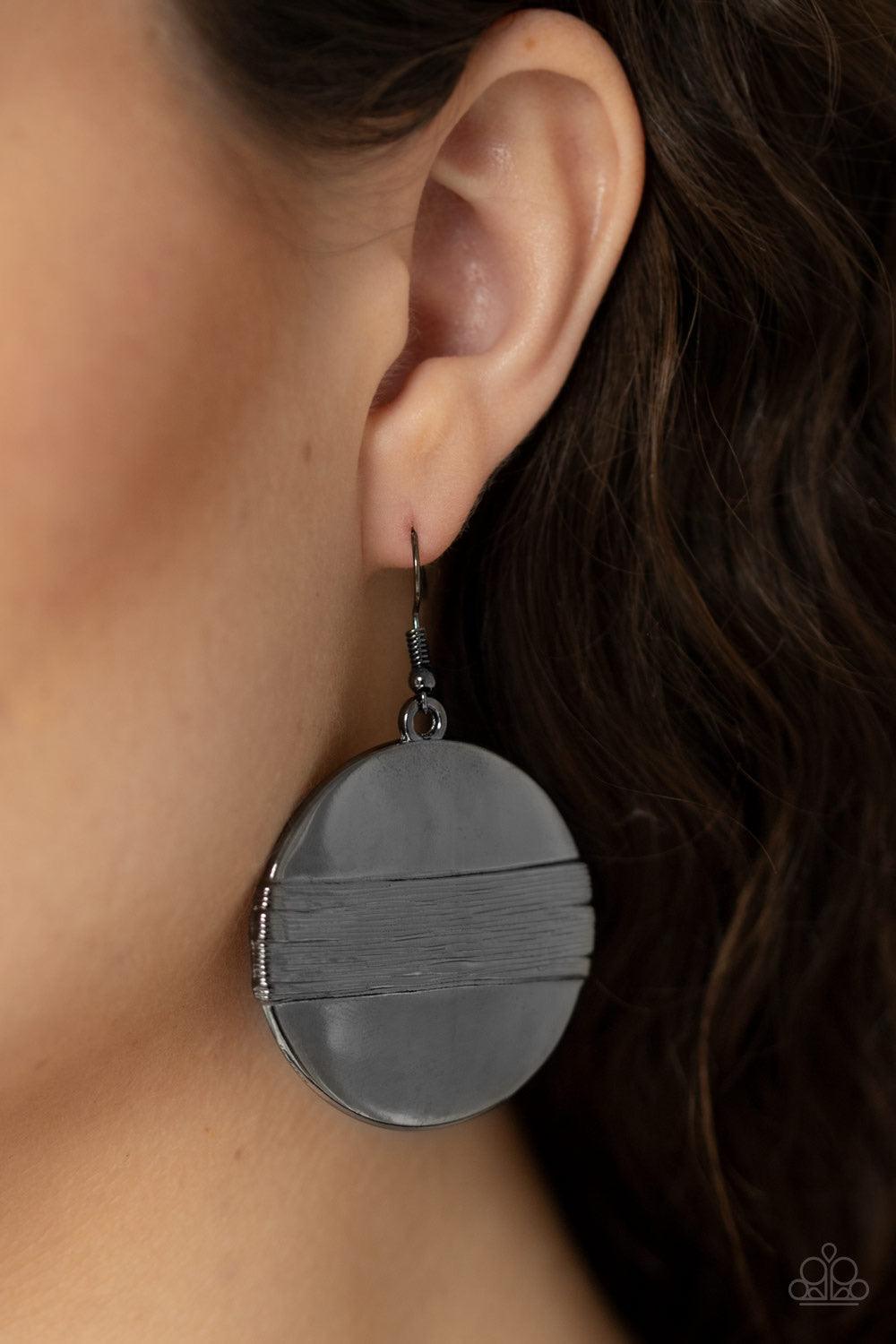 Paparazzi Accessories Ultra Uptown ~Black A textured gunmetal band wraps around the center of a glistening gunmetal disc, creating an edgy frame. Earring attaches to a standard fishhook fitting.
