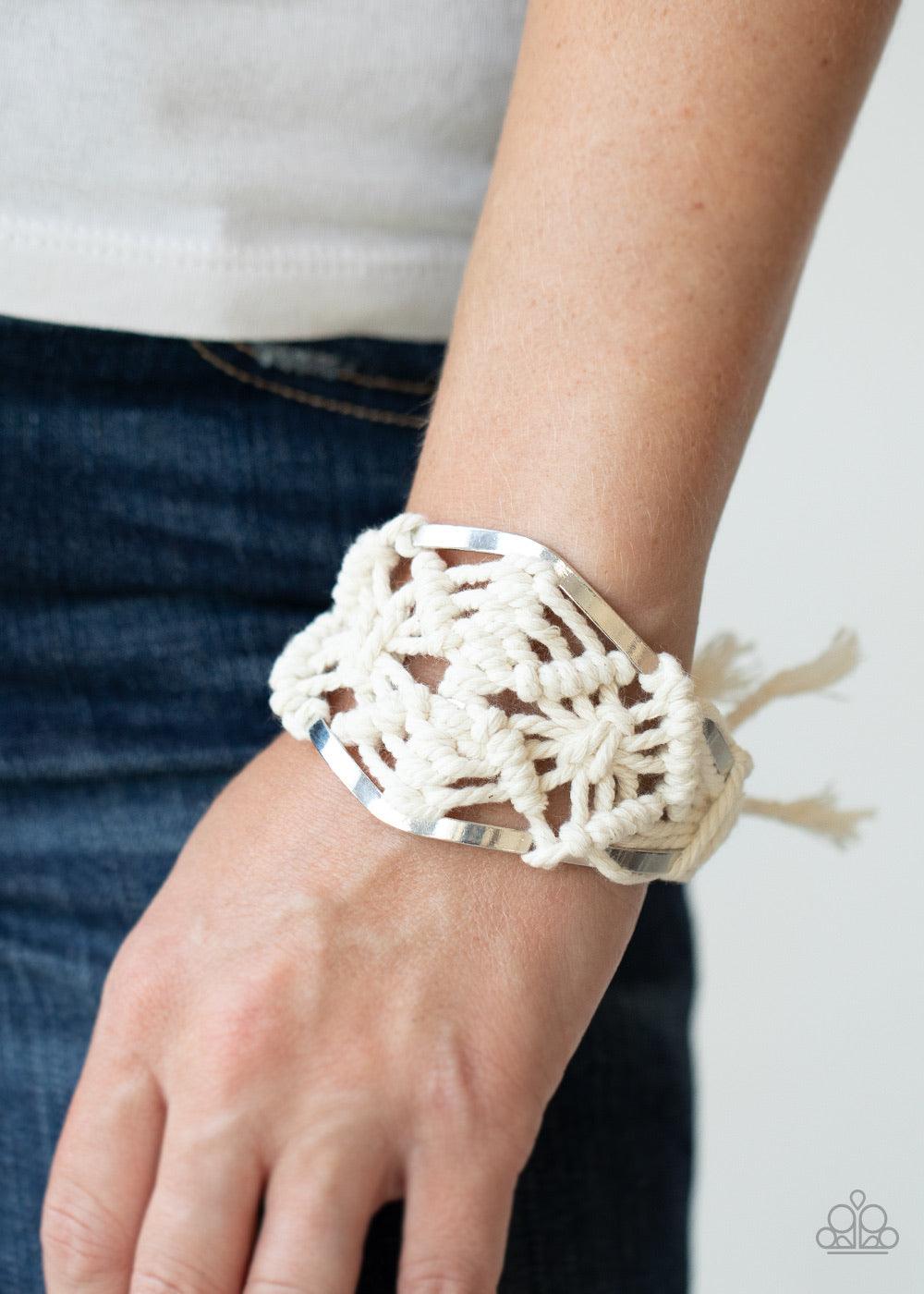 Paparazzi Accessories Macrame Mode - White White cording decoratively knots and weaves around an airy silver cuff for a macramé inspired look. Knotted around the ends, white tassels flair out from bottoms of the cuff for a wanderlust finish.Sold as one in