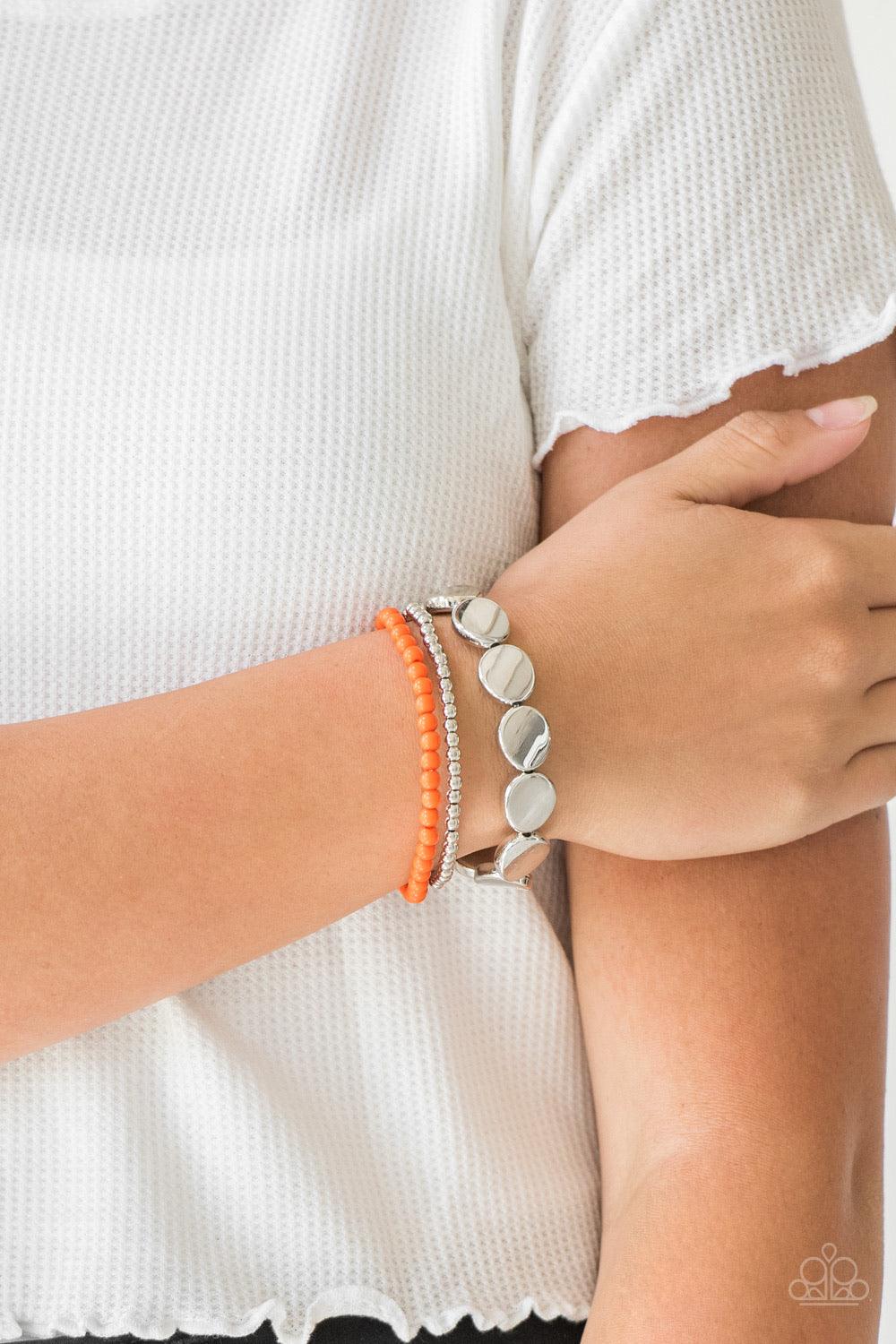 Paparazzi Accessories Beyond Basics - Orange Mismatched silver and orange beads and round silver accents are threaded along stretchy bands, creating colorful layers around the wrist. Sold as one set of three bracelets. Jewelry