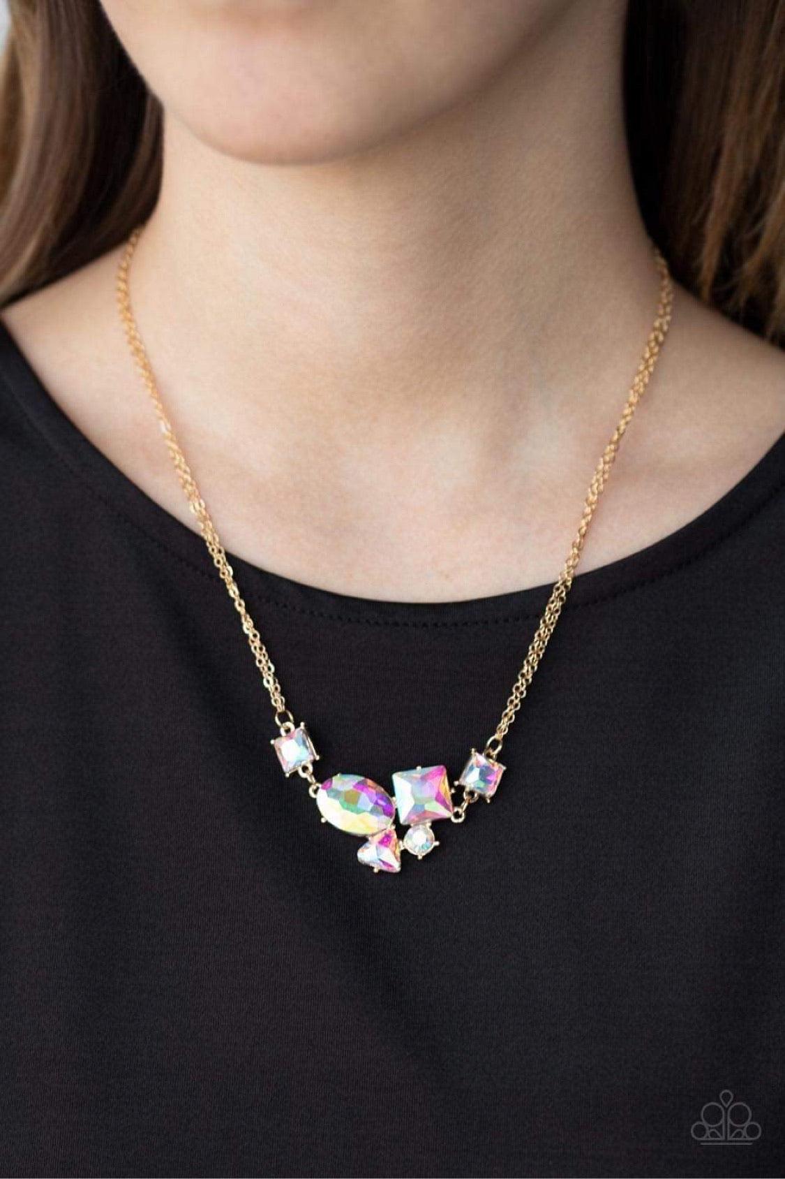 Paparazzi Accessories Constellation Collection - Multi Varying in shape and size, triangular, round, and square cut iridescent rhinestones coalesce into a floating pendant at the bottom of doubled gold chains, creating a stellar shimmer below the collar.