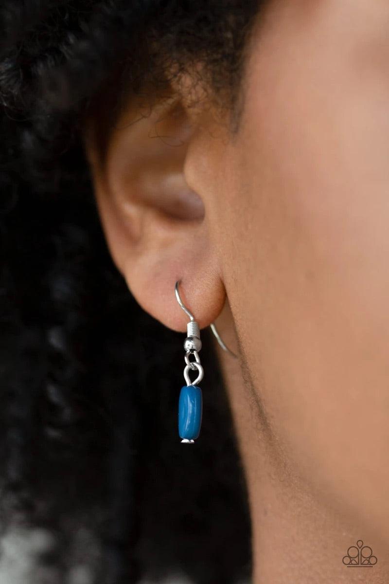 Paparazzi Accessories When in Roam - Blue A refreshing blue bead is pressed into the center of an antiqued silver crescent shaped pendant radiating with geometric patterns. Antiqued silver tassels swing from the bottom of a bold pendant, creating a fierce