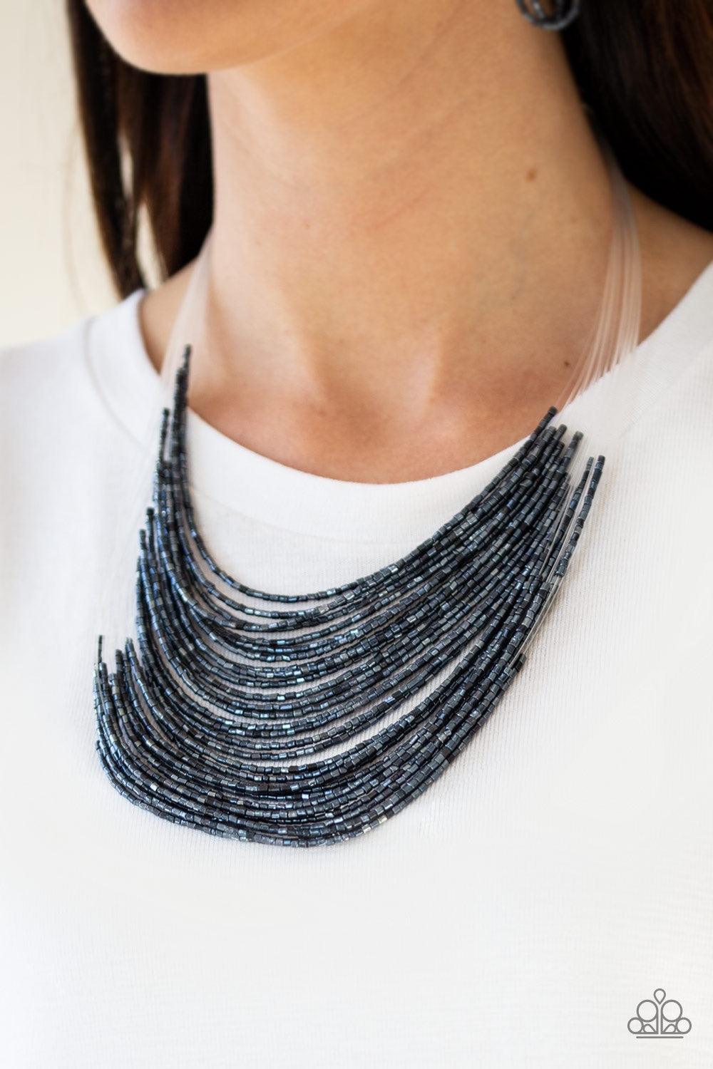 Paparazzi Accessories Catwalk Queen - Blue Strand after strand of metallic blue seed beads fall together to create a bold statement piece. Features an adjustable clasp closure. Jewelry
