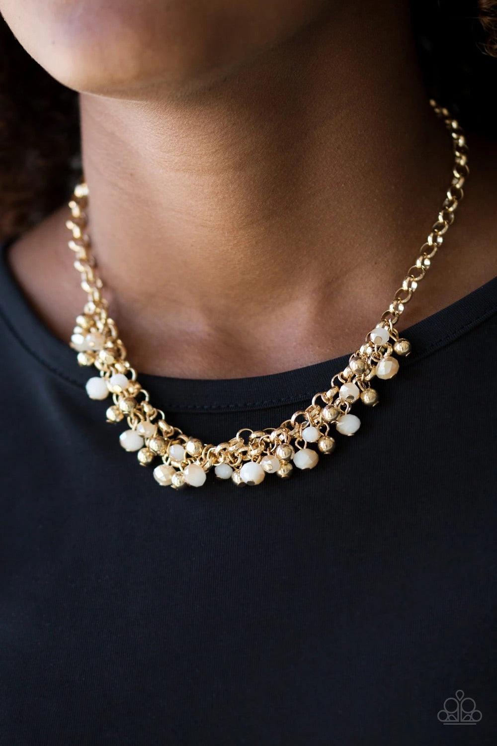 Paparazzi Accessories Trust Fund Baby - Gold Dipped into a golden metallic shimmer, faceted white beads and classic gold beads swing from interlocking gold chains, creating a refined fringe below the collar. Features an adjustable clasp closure. Sold as o