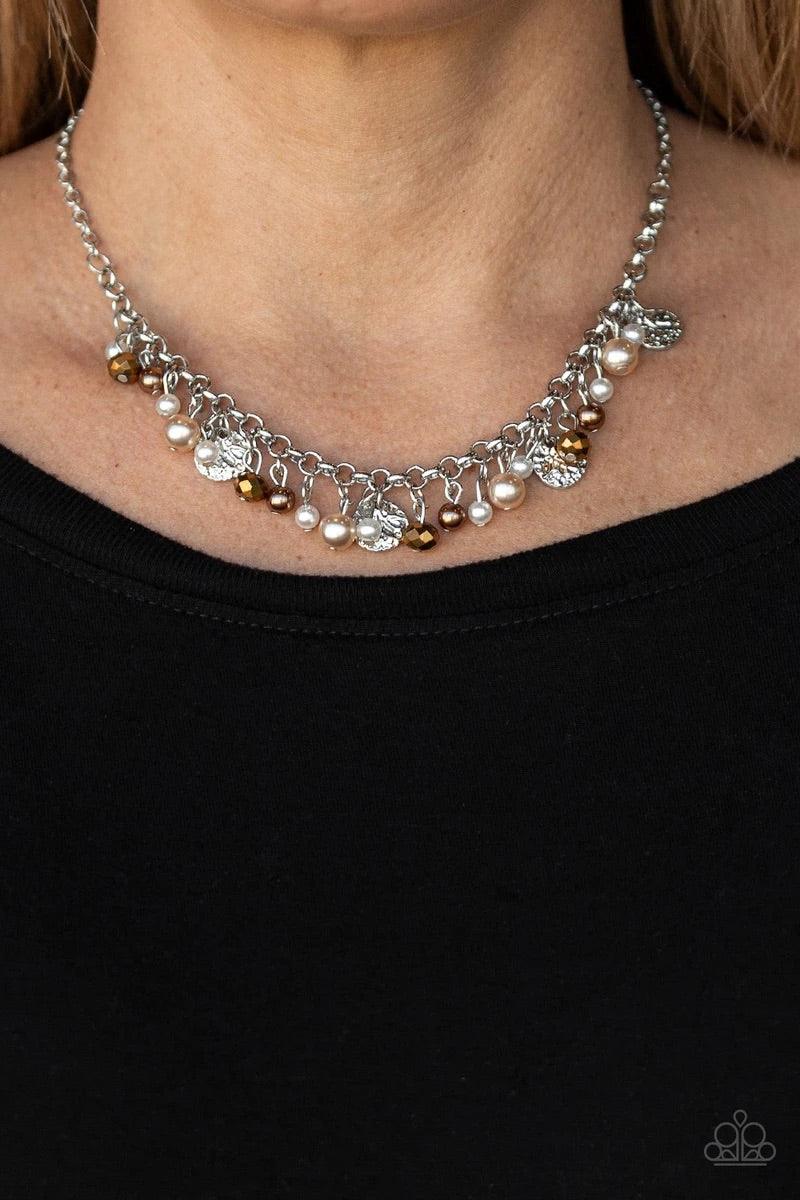 Paparazzi Accessories Coastal Cache - Mutli Pearly white and brown beads, aurum crystal-like gems, and hammered silver discs swing from a bold silver chain, creating a refined fringe below the collar. Features an adjustable clasp closure. Sold as one indi