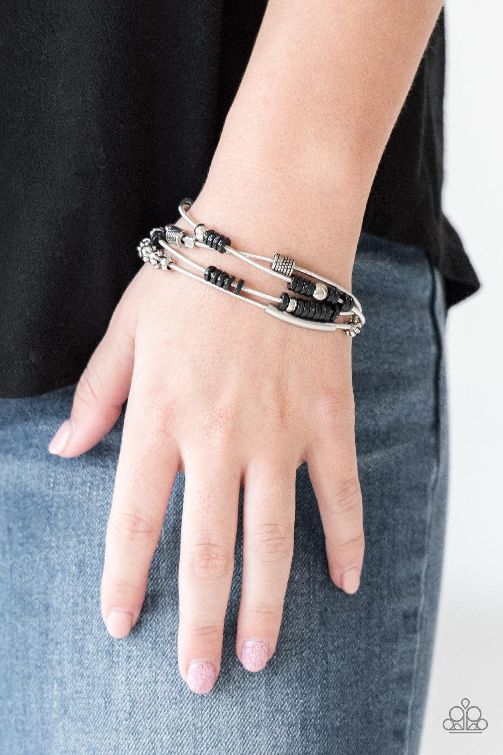 Paparazzi Accessories Tribal Spunk ~Black Mismatched silver accents and disc-shaped black beading slides along stretchy spring-like wires for a spunky tribal look. Sold as one set of four bracelets. Hostess Reward