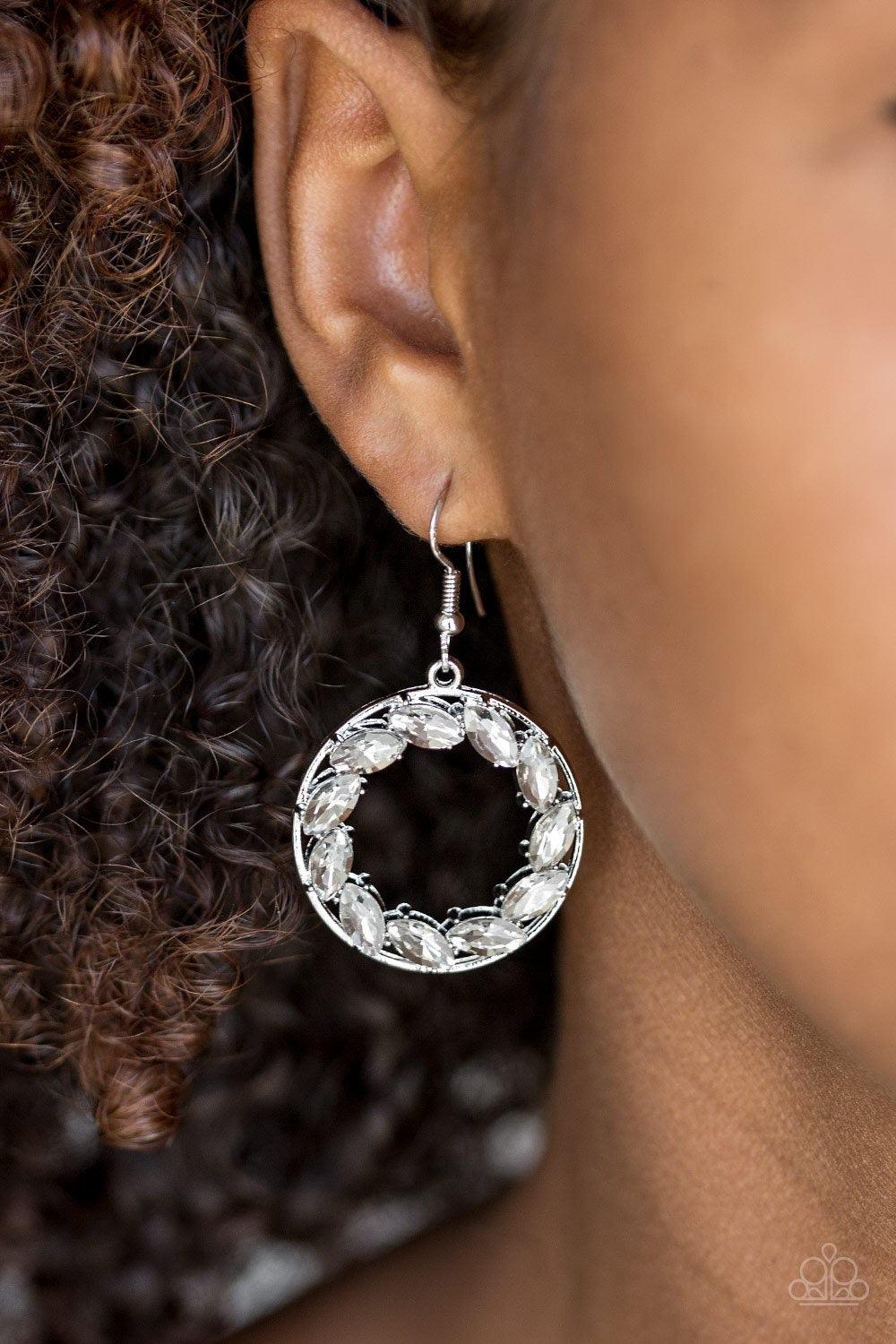 Paparazzi Accessories Global Glow - White Featuring regal marquise style cuts, glittery white rhinestones are encrusted along a shimmery silver hoop for a radiant fashion. Earring attaches to a standard fishhook fitting. Sold as one pair of earrings. Jewe